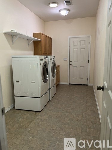 A laundry room with a washer and dryer stacked on top of each other.