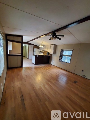 A room with wooden floors and a ceiling fan.
