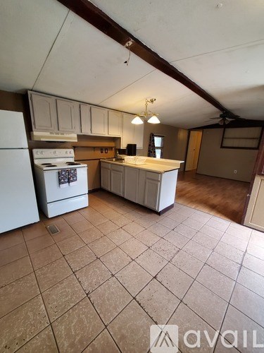 A kitchen with a white stove and a white refrigerator.