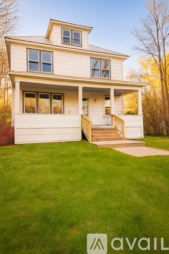 A two-story house with a white exterior and a garage.