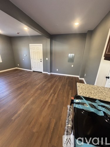 A room with wooden floors and a white door.