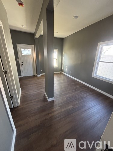 A room with wooden floors and a white door.