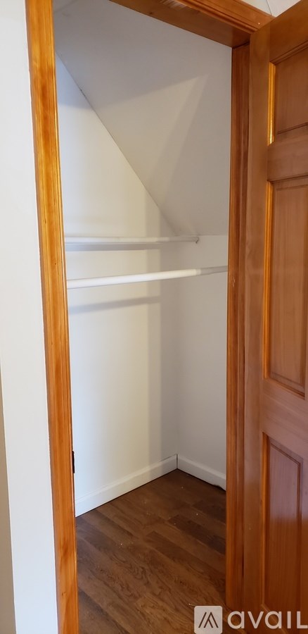 A wooden door frame with a white wall in the background.
