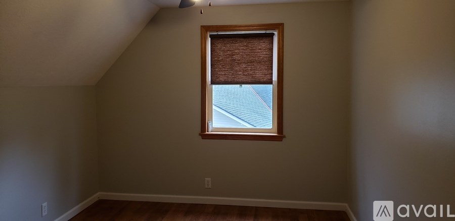 A room with a window and a ceiling fan.