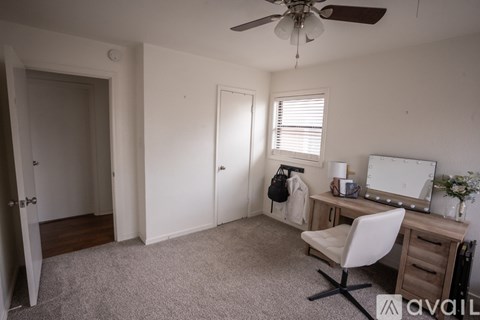 A room with a desk and a chair.