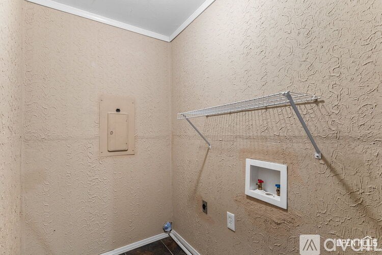 A bathroom with a shower rod and a picture frame on the wall.
