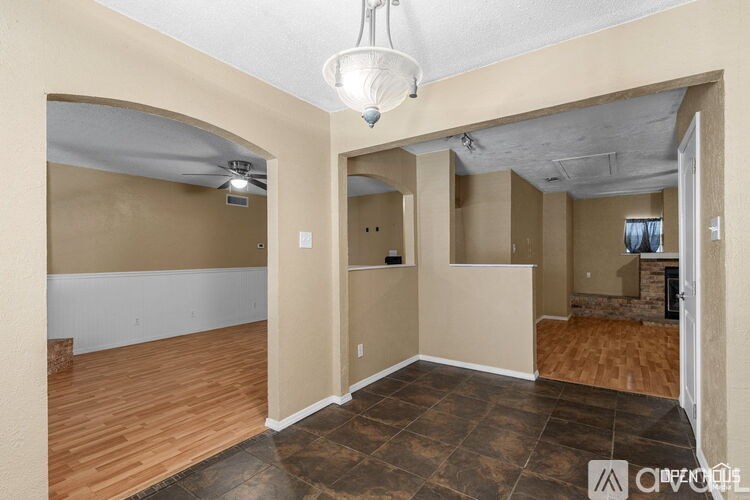 A room with a wooden floor and a ceiling fan.