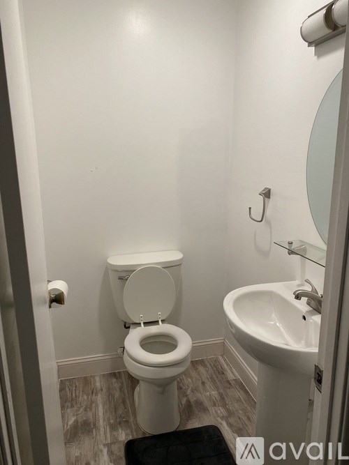 A white toilet with a sink next to it in a bathroom.