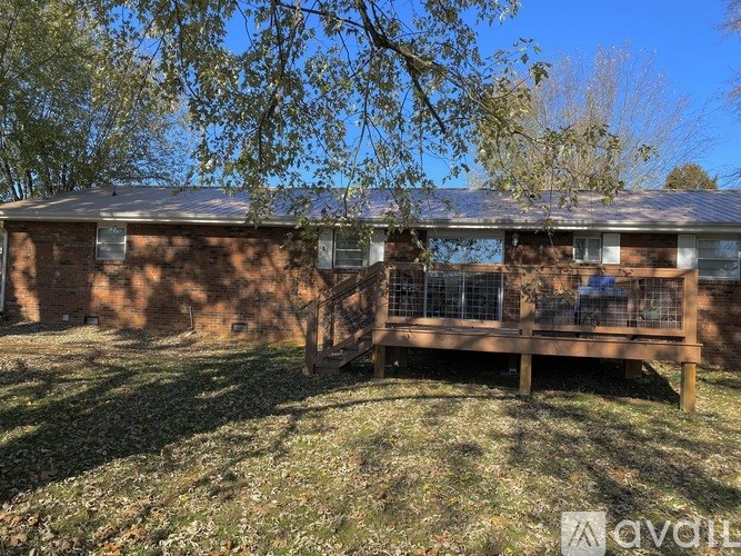 A house with a brown roof and a wooden deck.
