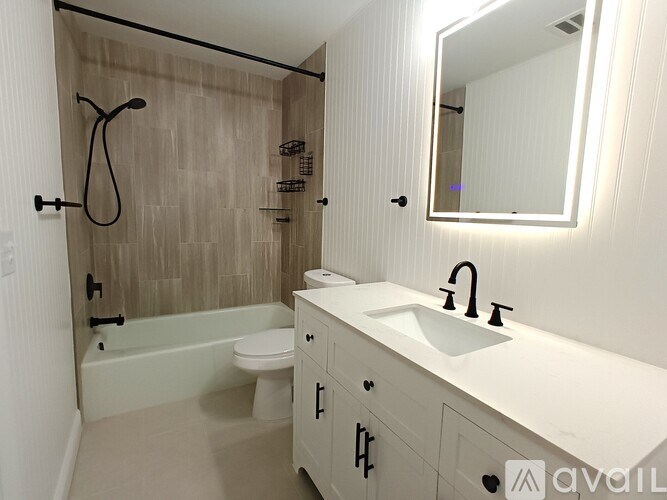 A bathroom with a white sink and a white toilet.