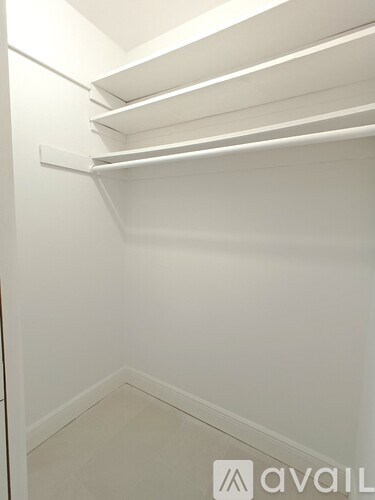 Empty white shelves in a room.