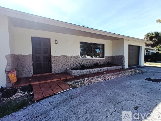 A house with a black door and a window is shown.