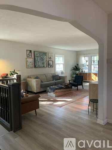 A living room with a sofa set, a coffee table, and a chair.