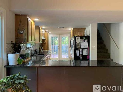 A kitchen with a refrigerator on the right side.