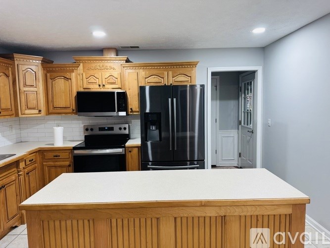A kitchen with wooden cabinets and a white countertop.