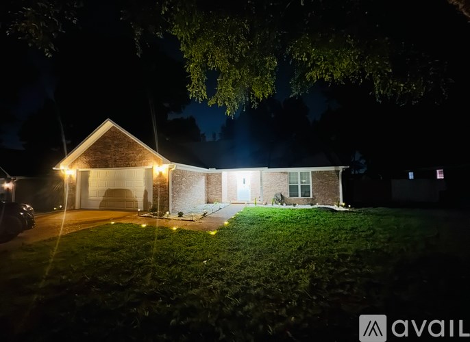 A house with lights on at night.