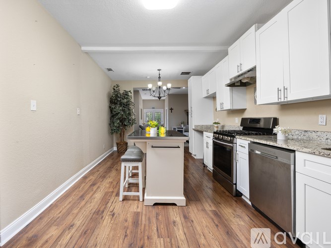 A kitchen with white cabinets and stainless steel appliances.