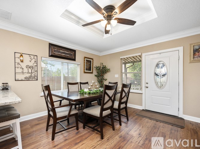 A dining room with a table set for four.