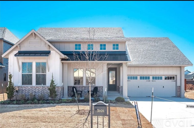 A house with a front yard and a sign that says "3605".