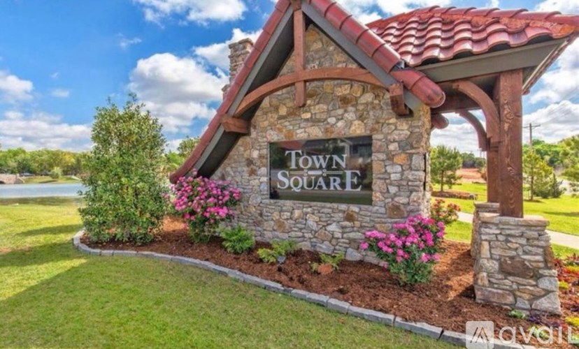 A stone building with a sign that says "Town Square".