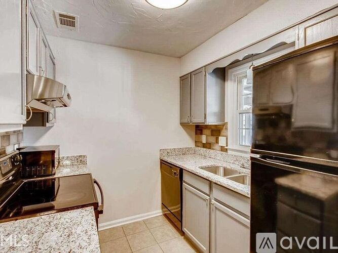 A kitchen with granite countertops and stainless steel appliances.