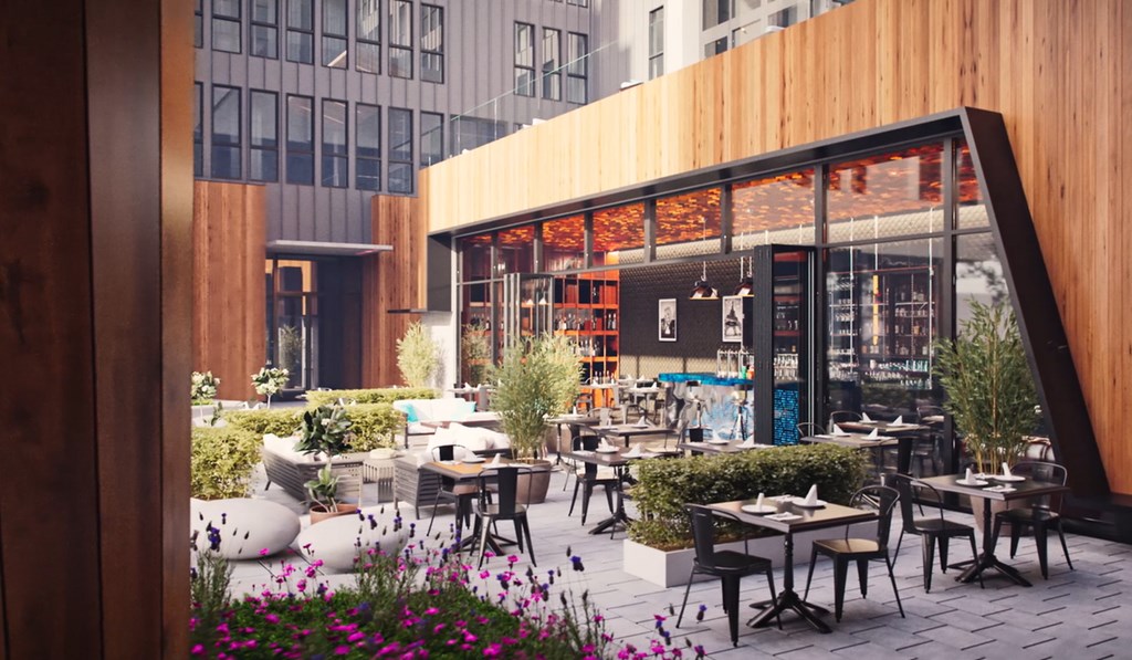 A modern outdoor cafe with wooden tables and chairs.