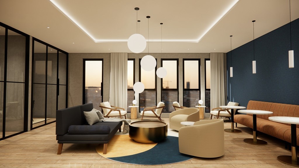 A modern living room with a black sofa, white chairs, and a round coffee table.