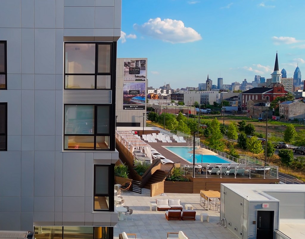 A modern building with a pool and a view of the city.