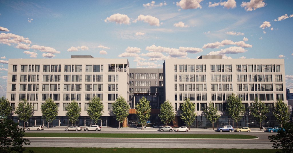 A large building with a parking lot in front of it.