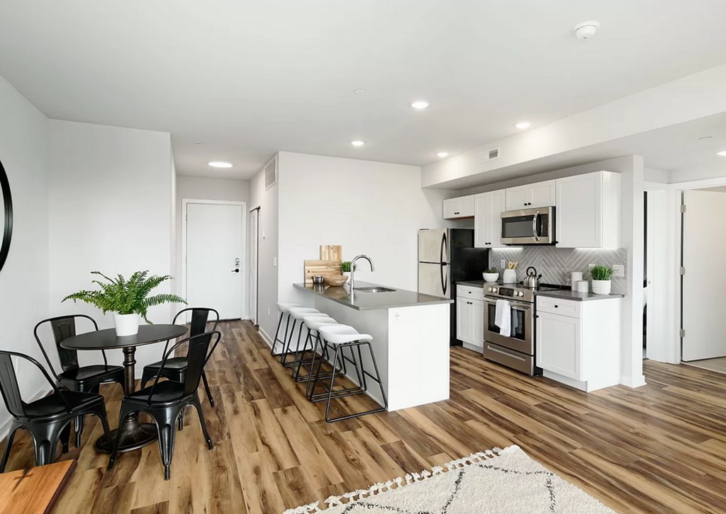 A modern kitchen with a dining table and chairs.