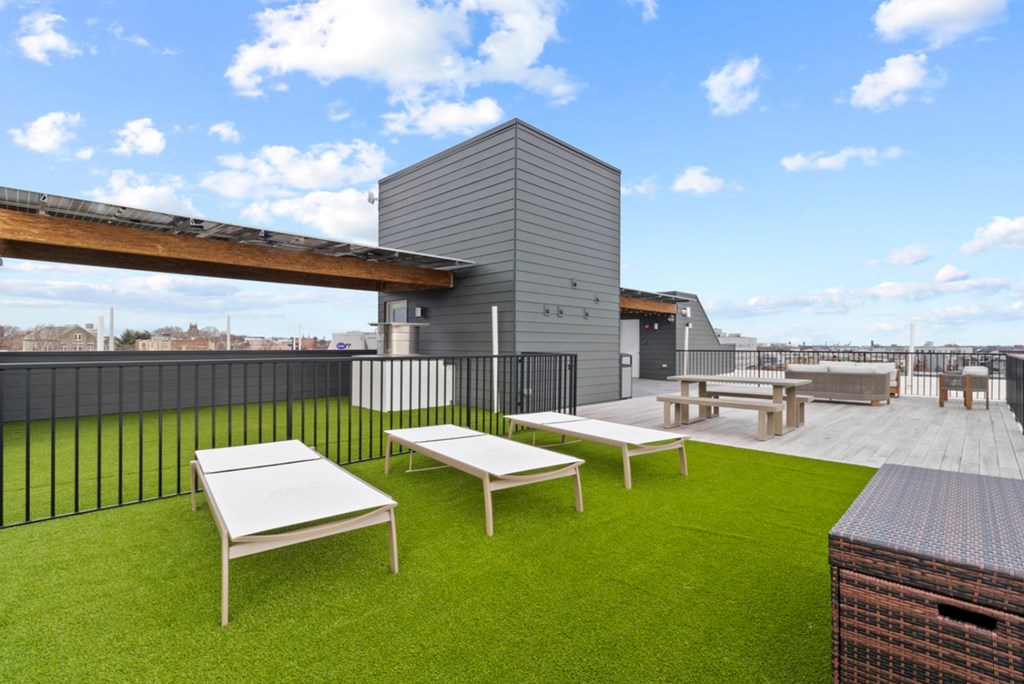 A rooftop patio with tables and chairs.