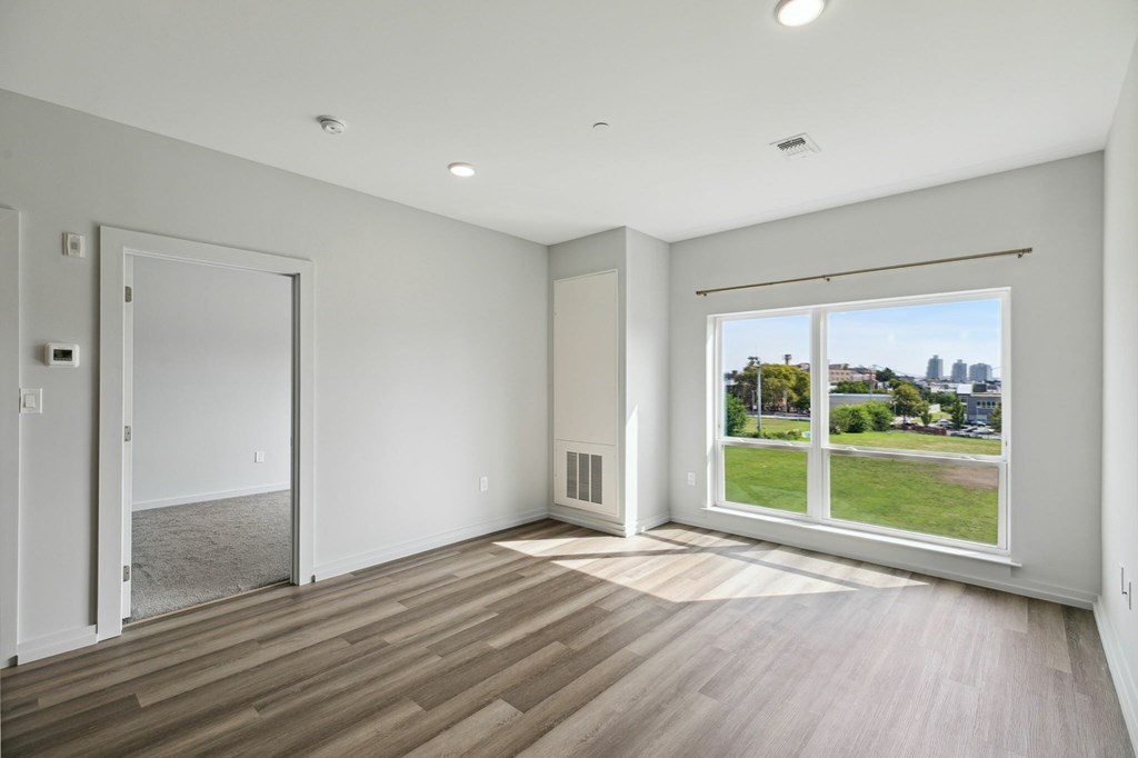 A large empty room with a view of the city.
