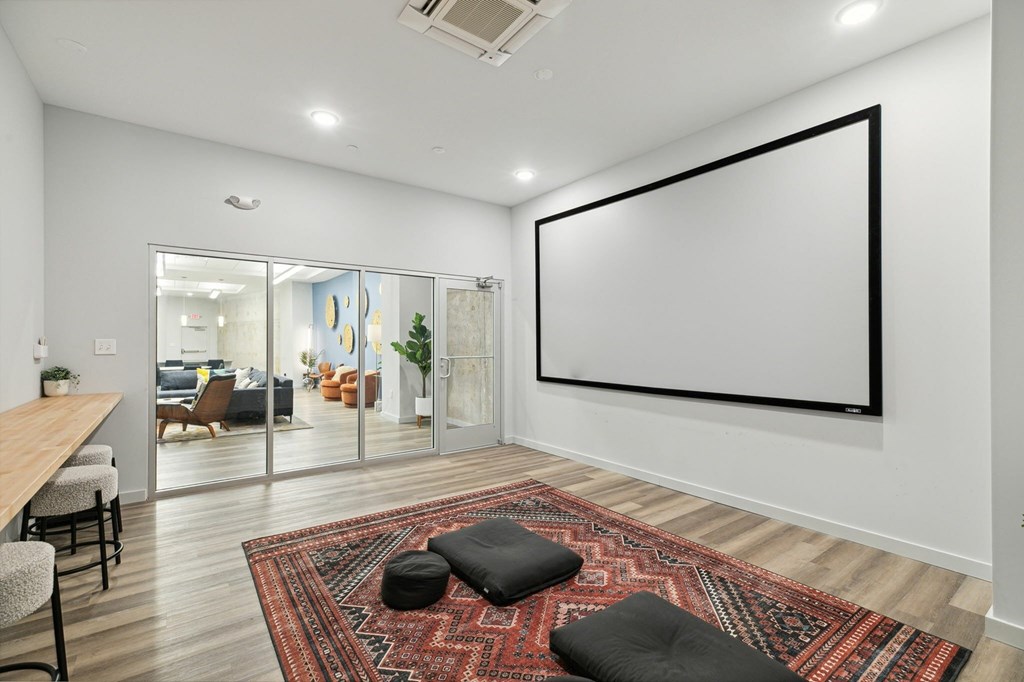 A room with a large poster on the wall and a rug on the floor.