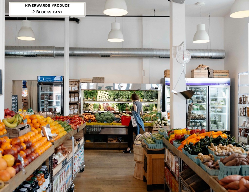 A woman is shopping in a produce section of a grocery store.