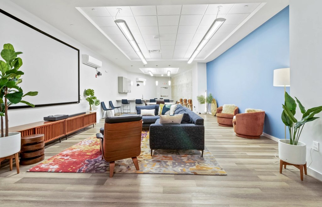A modern office space with a blue accent wall and wooden furniture.