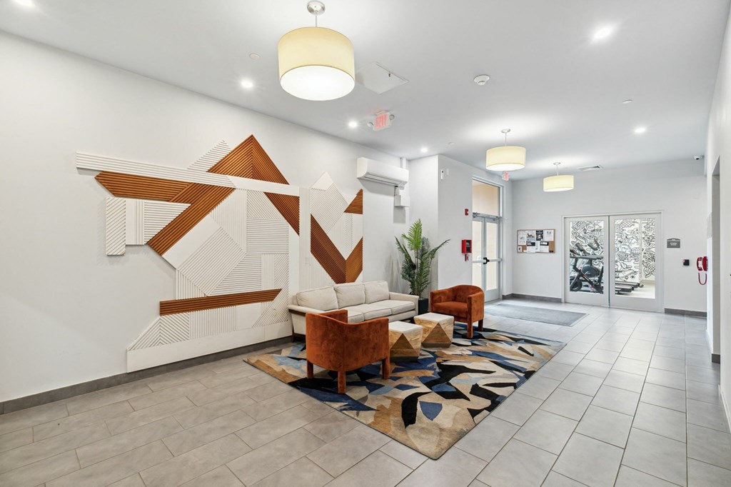 A modern living room with a large abstract art piece on the wall.