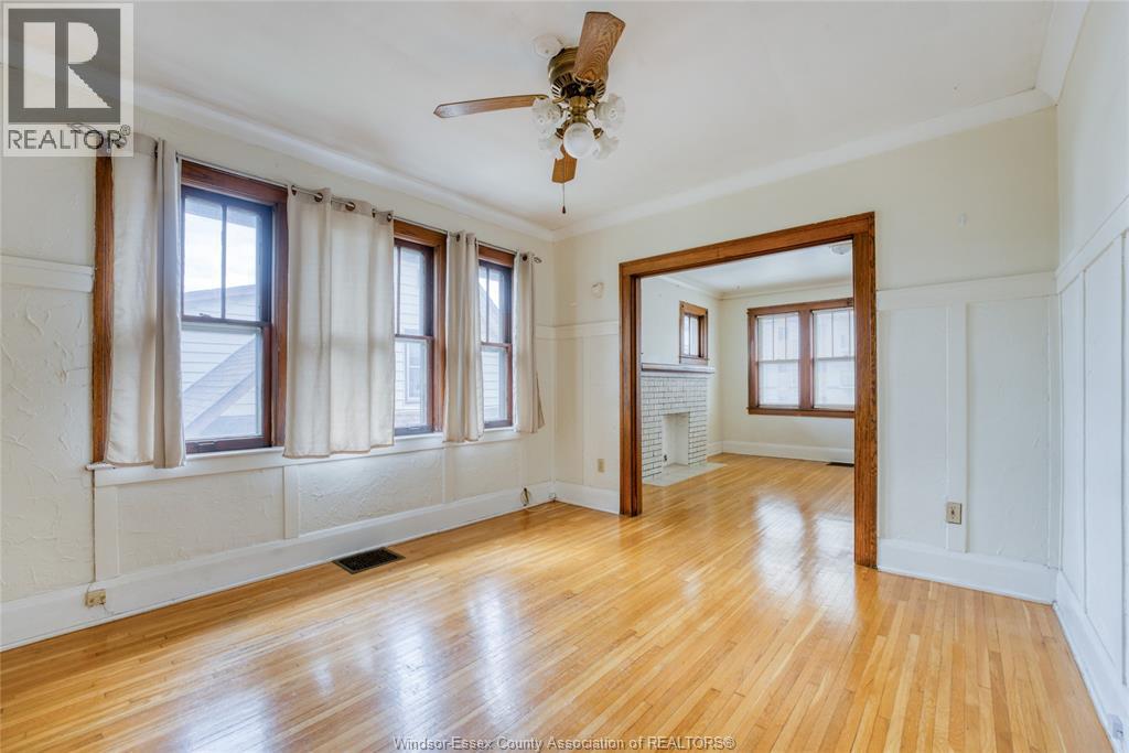 A room with wooden floors and a ceiling fan.