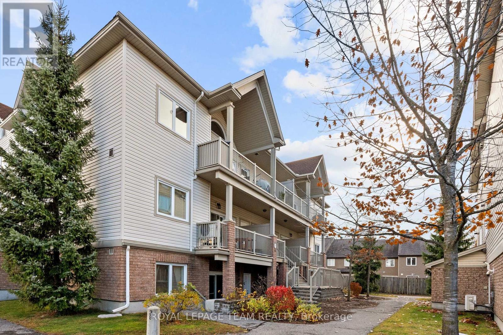 A multi-story residential building with a balcony on the second floor.