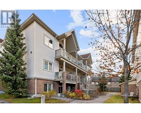 A multi-story residential building with a balcony on the second floor.
