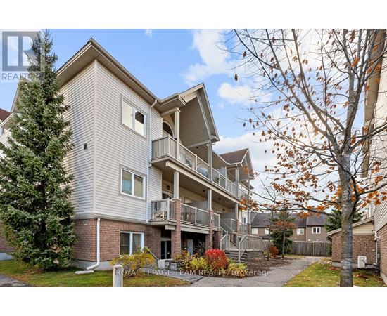 A multi-story residential building with a balcony on the second floor.