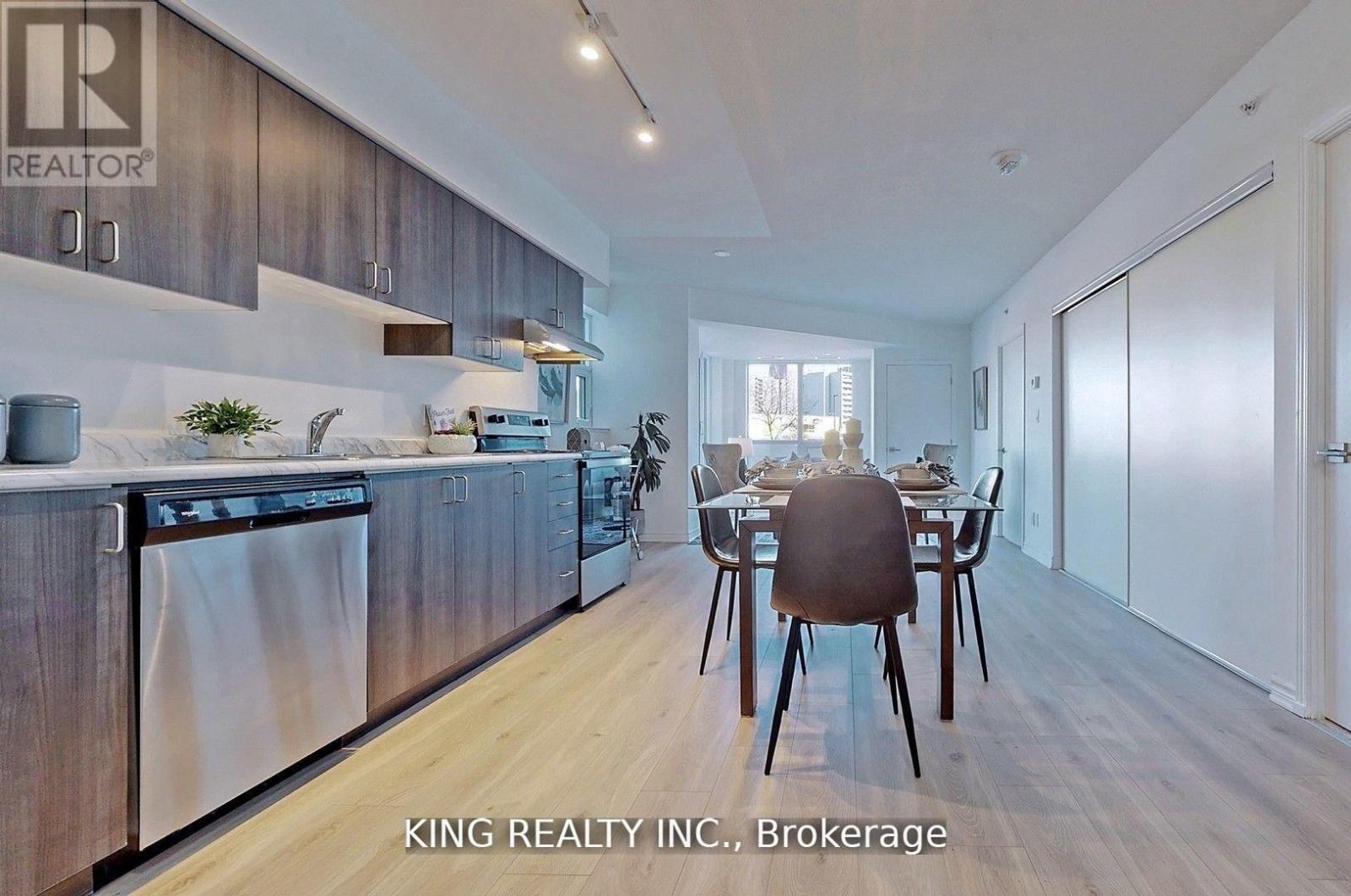 A modern kitchen with a dining table set for two.