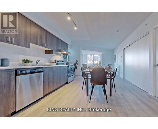 A modern kitchen with a dining table set for two.