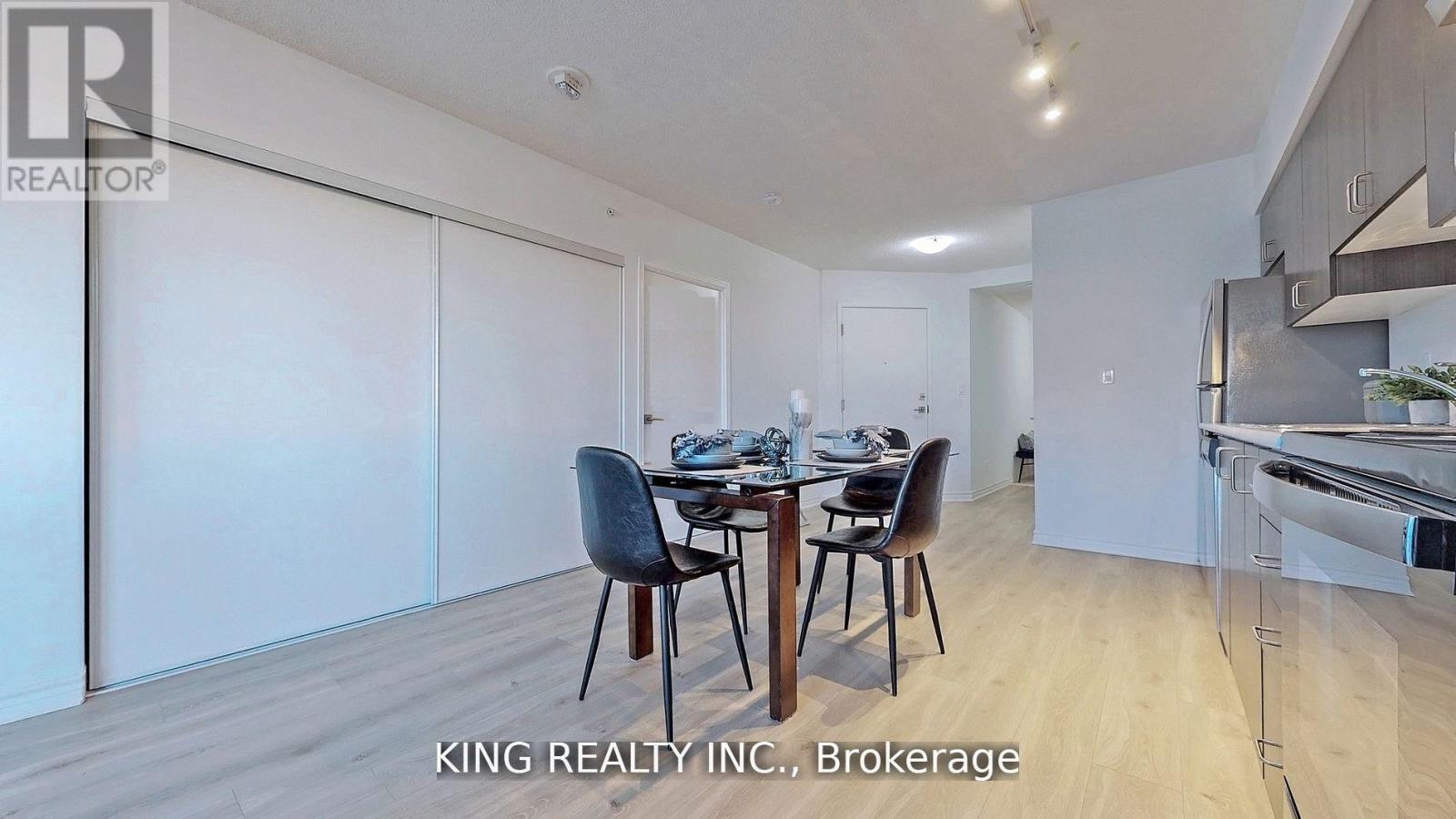A dining room with a table set for four.