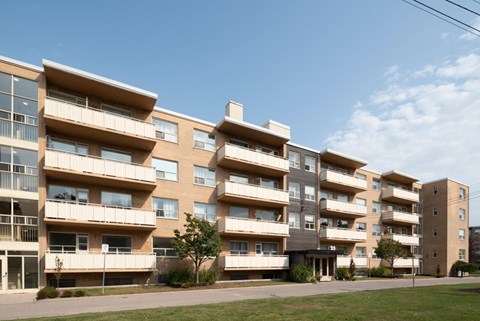 A large apartment complex with multiple balconies and windows.