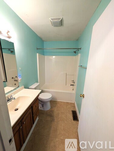 A backyard with a wooden fence and trees.