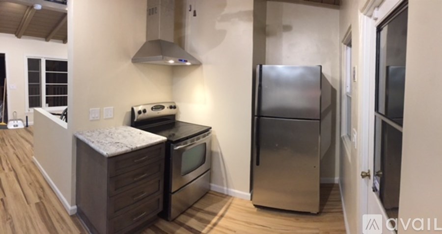 A kitchen with a stove, oven, and refrigerator.