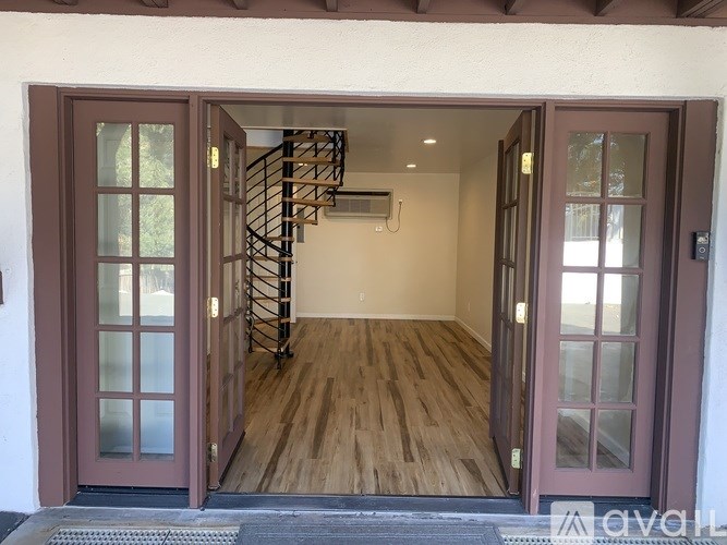 A wooden staircase leads to a second floor inside a house.