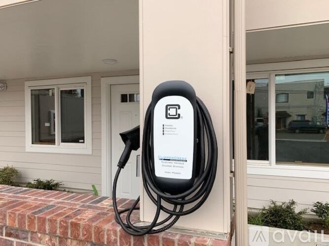 An electric vehicle charging station is plugged into a house.