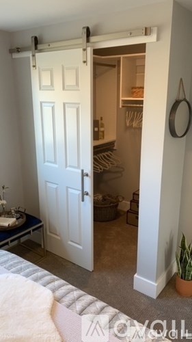 A white door with a white frame is open to a small kitchen.