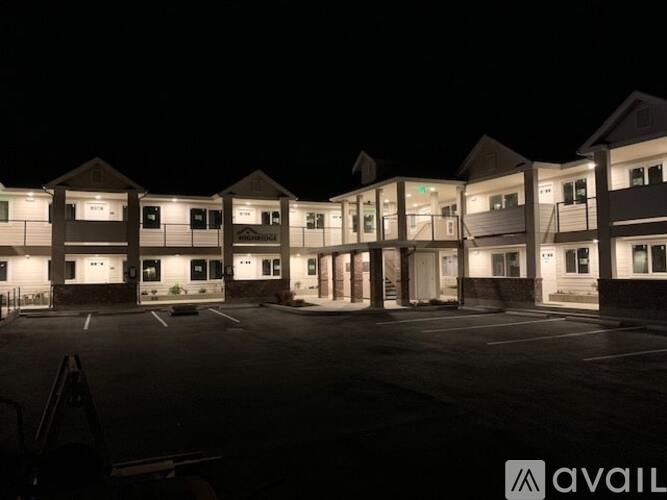 A parking lot at night with a building in the background and the word "AVAIL" on the bottom right.
